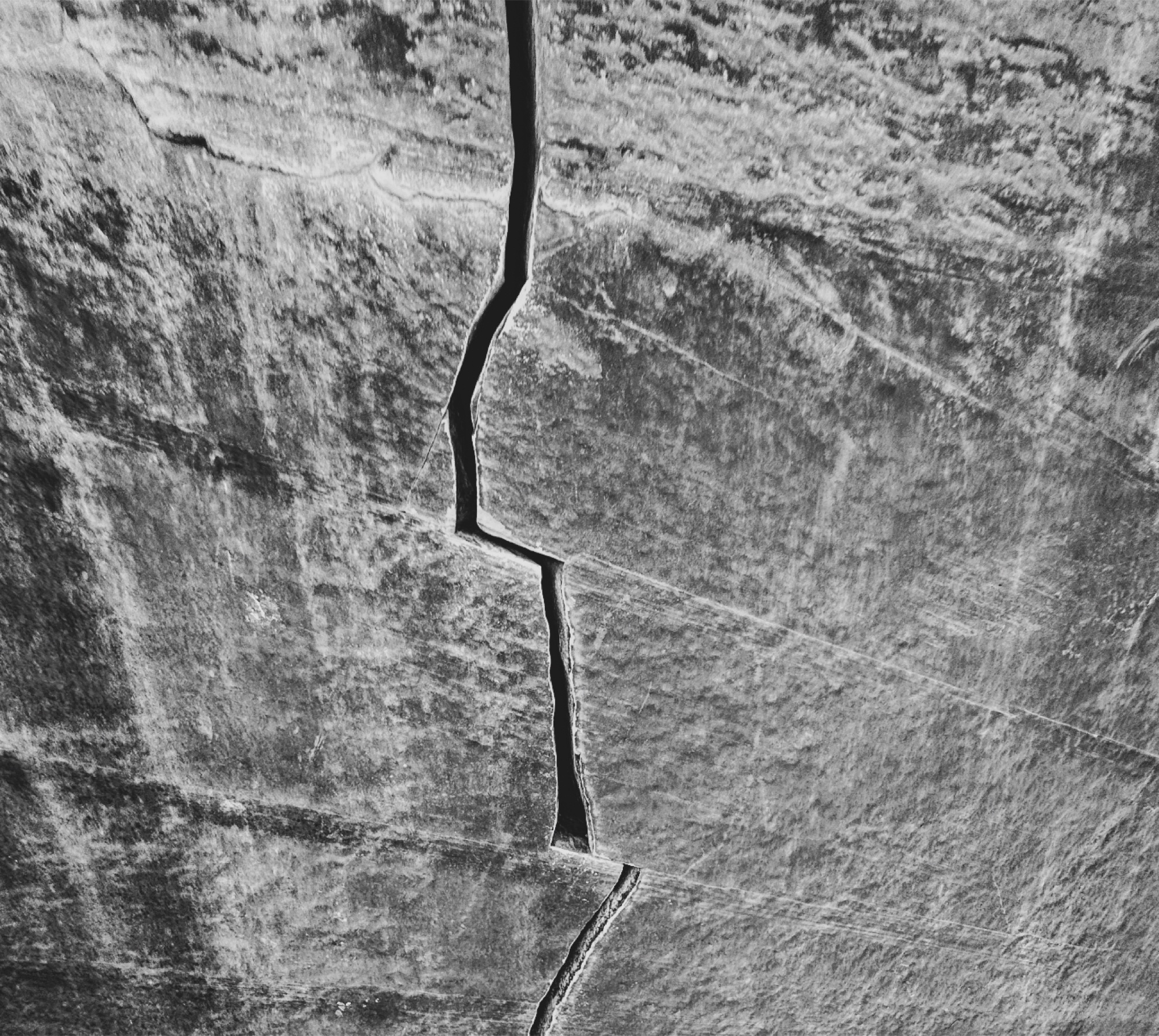 A crack running through weathered stone