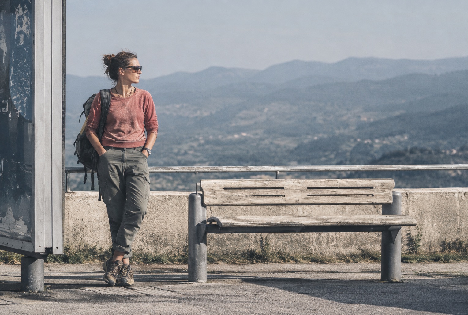 Marta resting at a mountain overlook, looking out