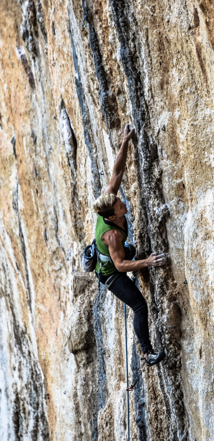 A climber on steep limestone, under load
